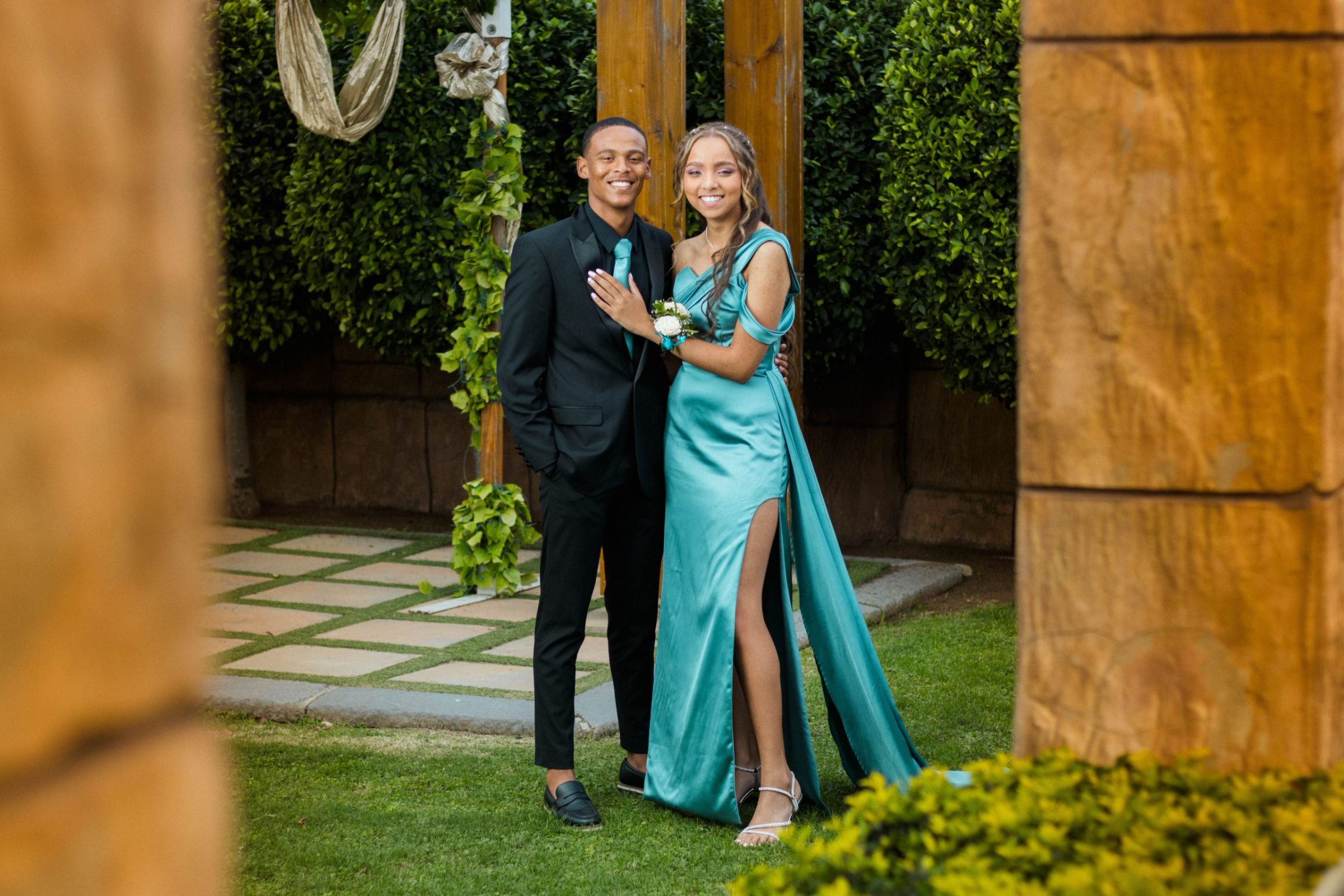 Matriculant couple posing in their evening wear in a garden